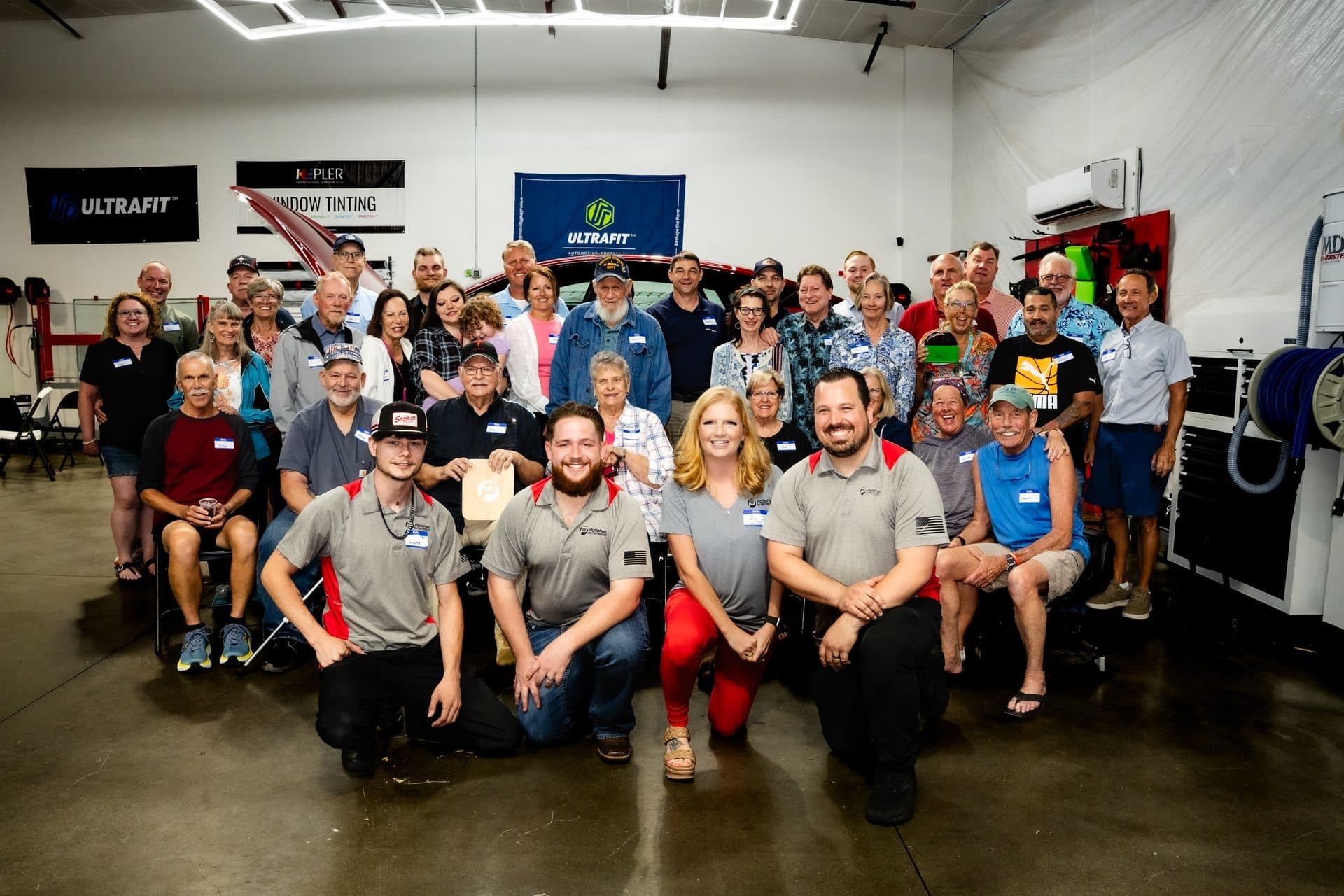 The Polished to Perfection team with a big group of customers at a customer appreciation dinner in the shop