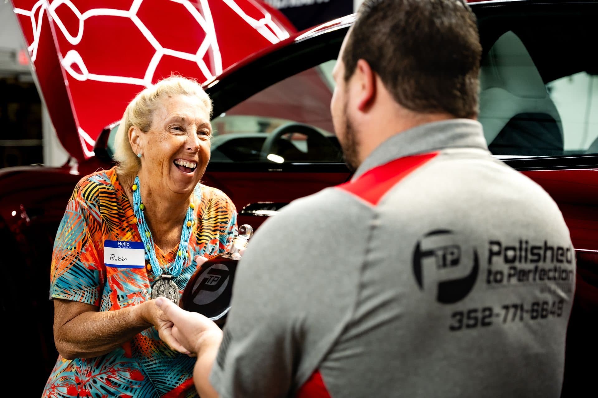 A customer laughing with a Polished to Perfection team member