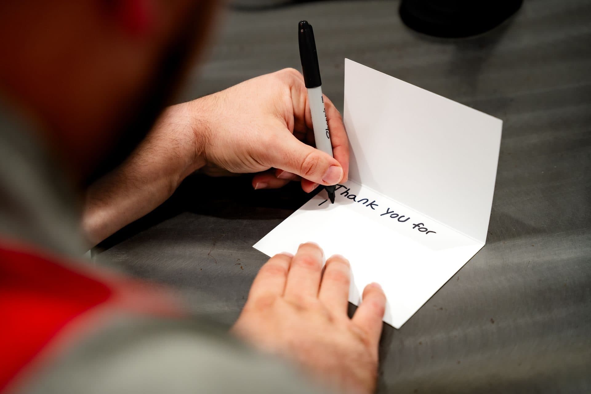 Chais writing a thank-you note by hand